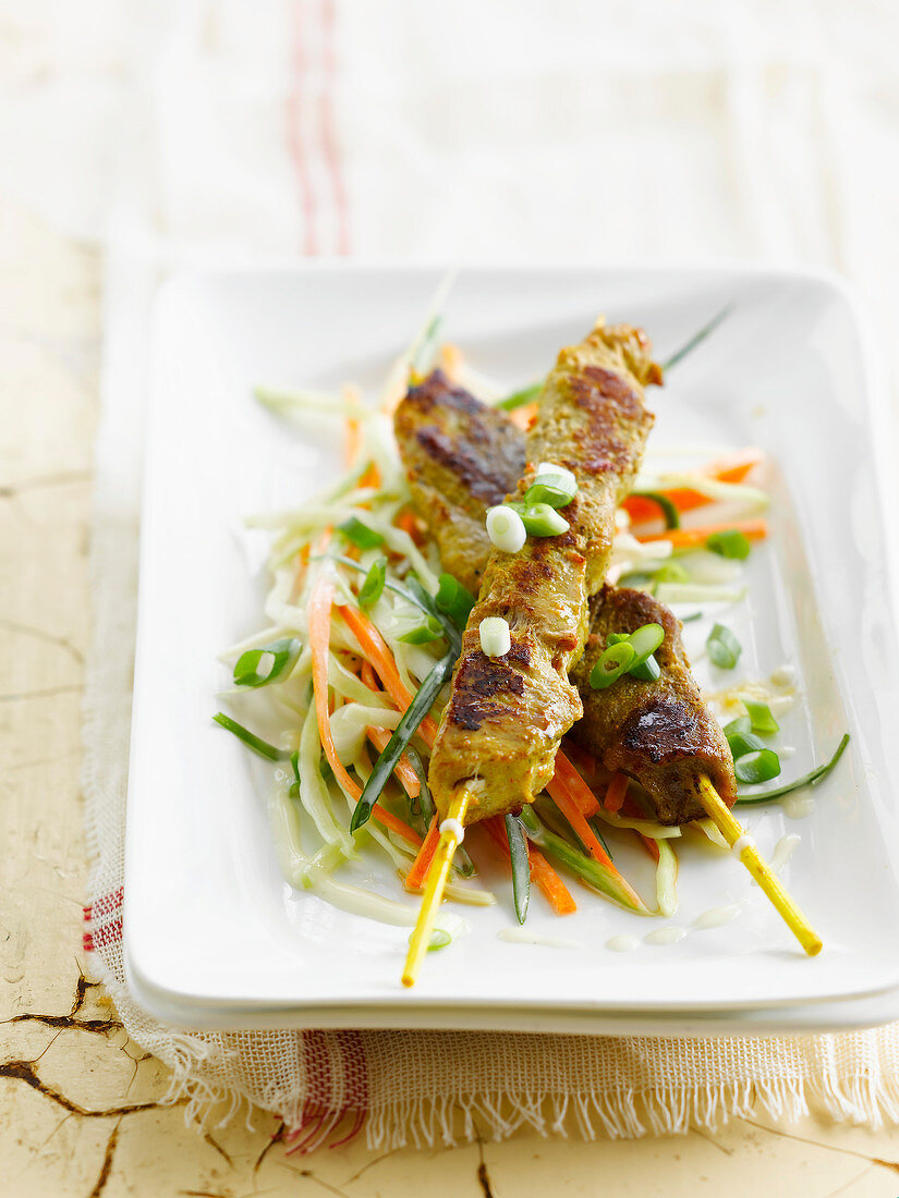 Curried chicken brochettes with crisp vegetable salad