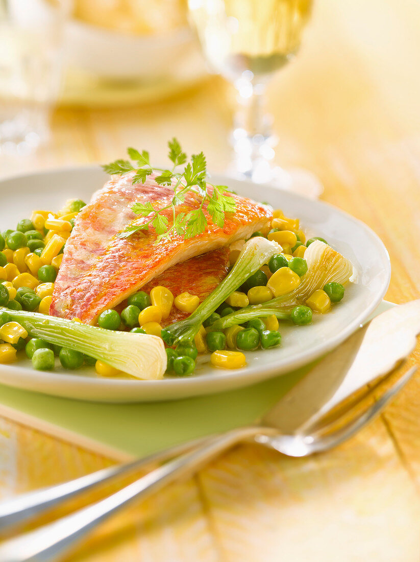 Pan-fried red mullet fillets with peas,sweet corn and spring onions