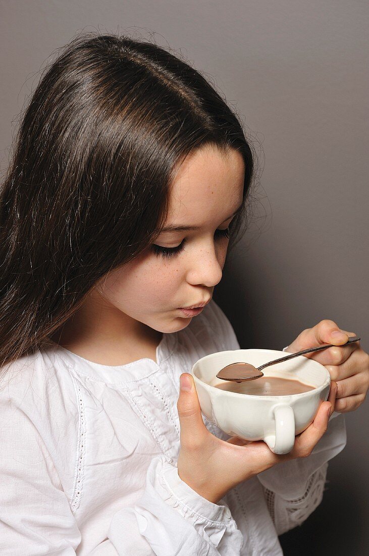 Young girl drinking hot chocolate