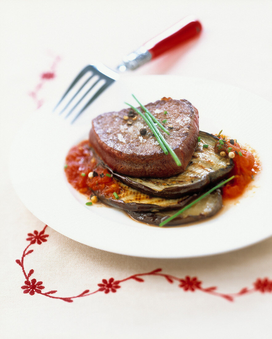Steak with eggplants and peeled tomatoes