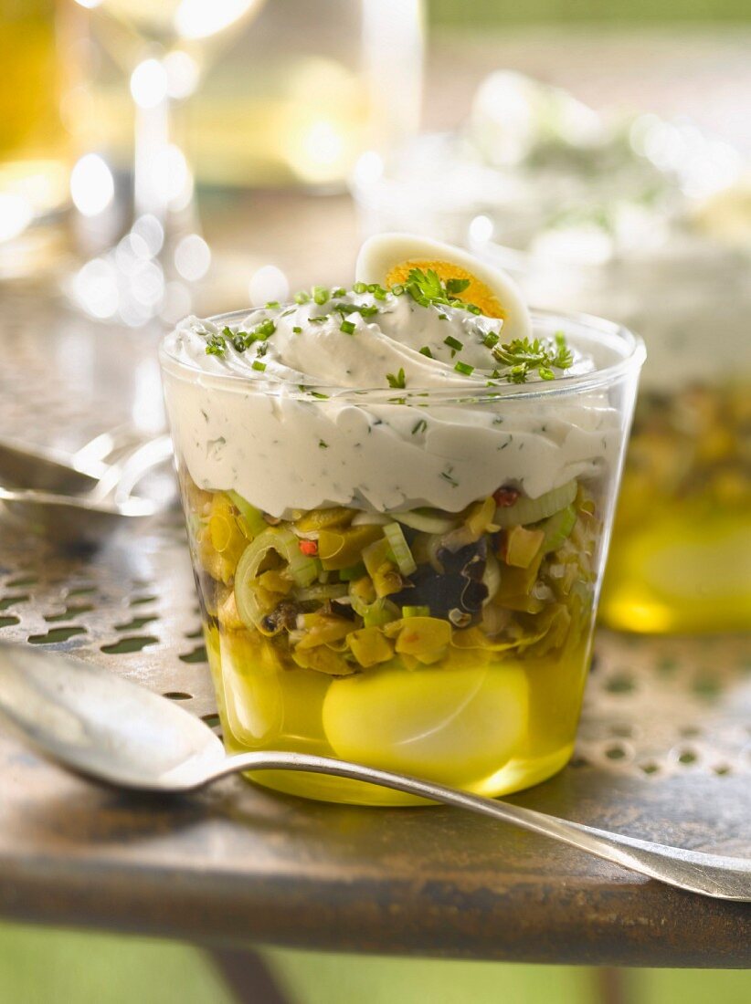 Quail's egg in aspic, crushed green olive and whipped cream with herb Verrine