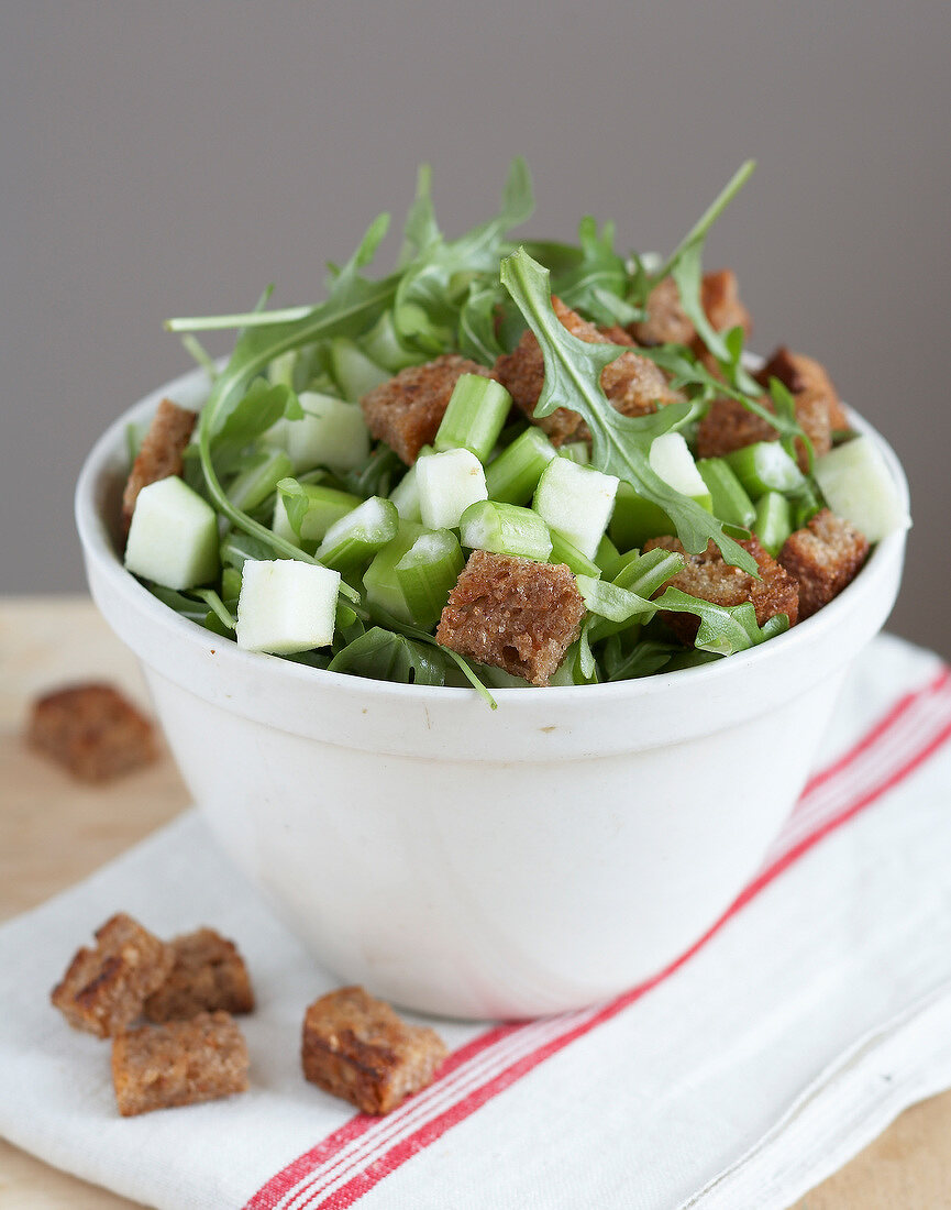 Rocket lettuce,apple,celery stalk and diced gingerbread salad