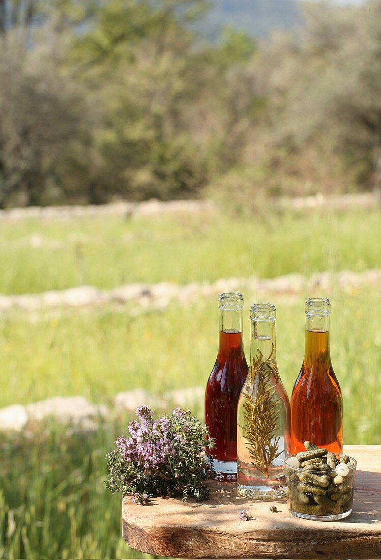 Three bottles of assorted vinaigars outdoors