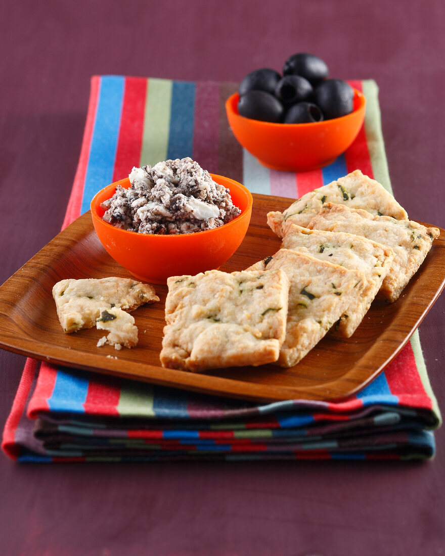 Parmesan shortbread cookies and cream of black olives