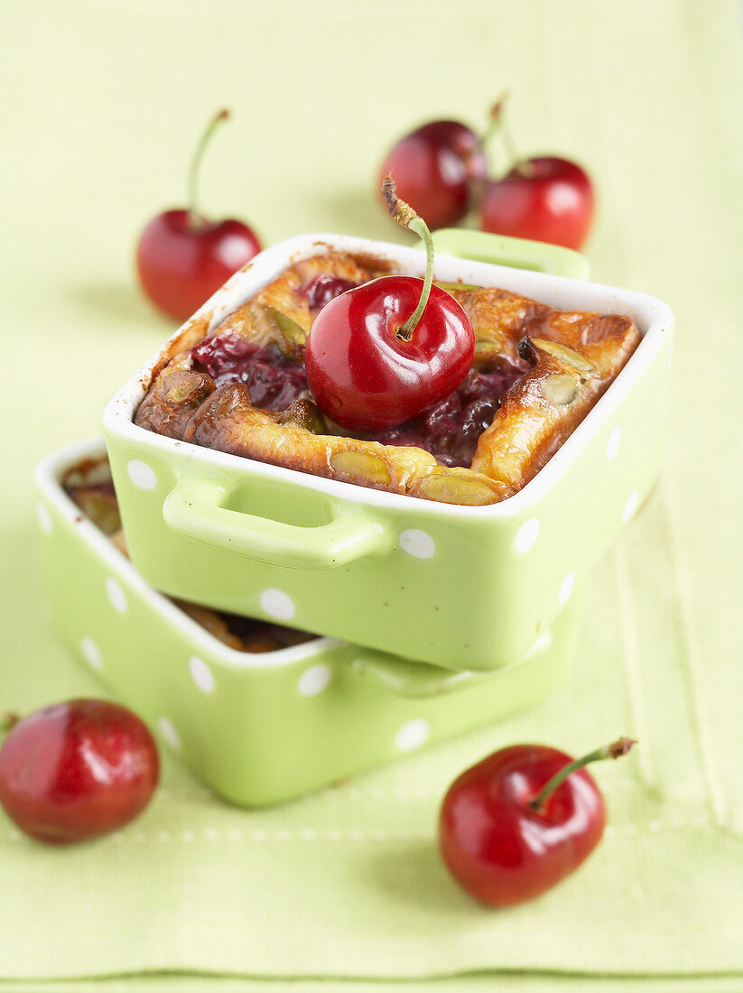 Individual cherry and pistachio batter puddings
