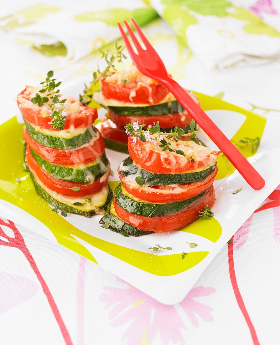 Tomato-zucchini mille-feuille topped with grilled chees