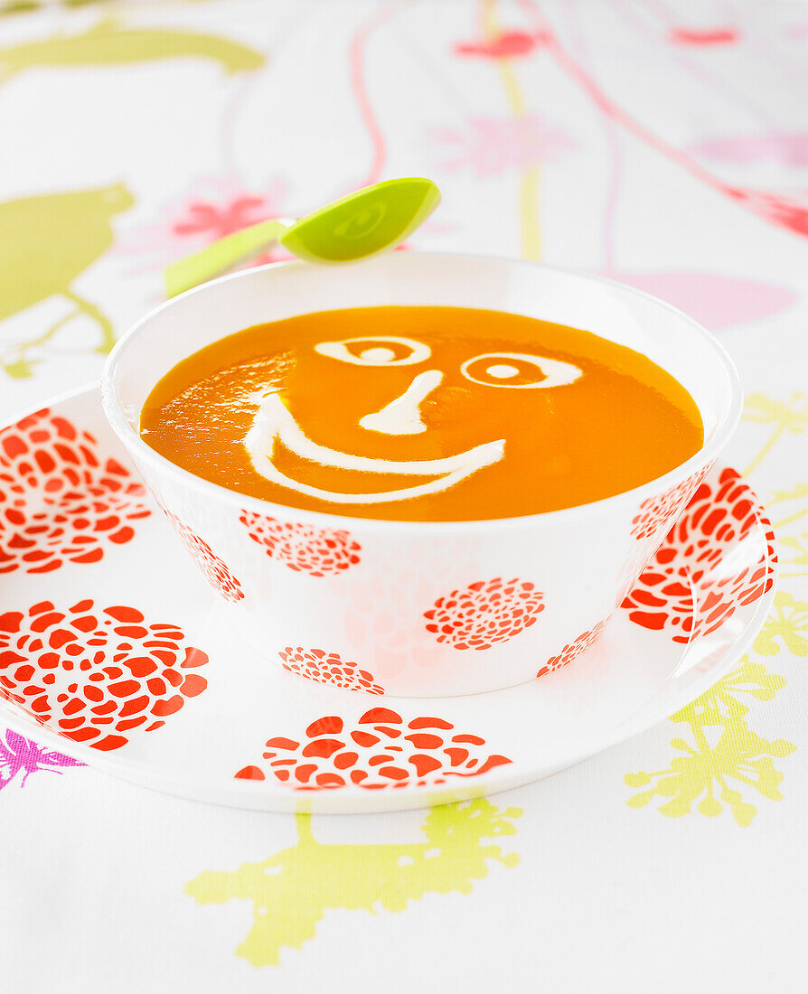Pumpkin soup with a creamy smiling face