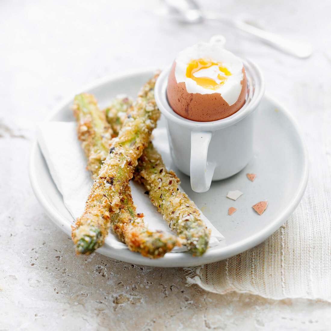 Soft-boiled egg with breaded asparagus