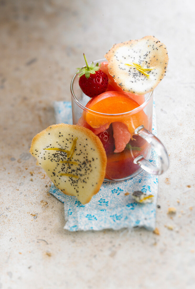 Fruit salad with poppy seed tuiles