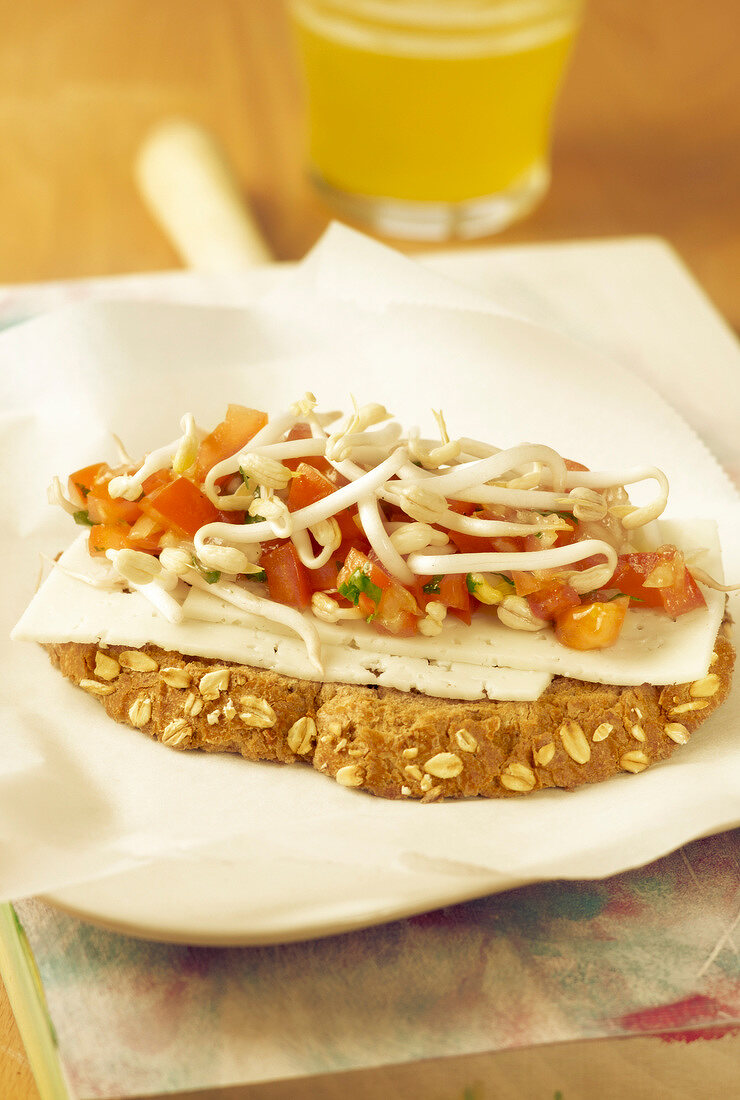 Goat's cheese, tomato and beansprout open sandwich