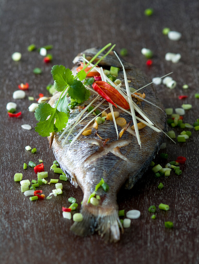 Baked sea bream with scallion,cilantro and chili peppers