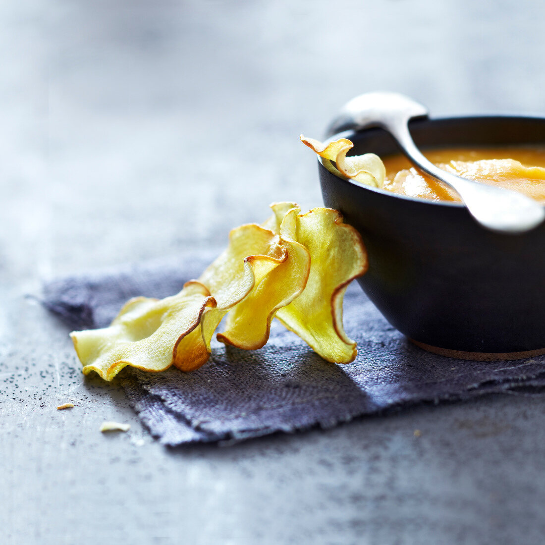 Cream of carrot soup with parsnip crisps