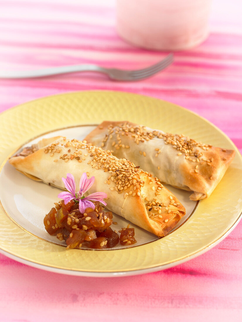 Small caramelized apple strudel topped with sesame seeds