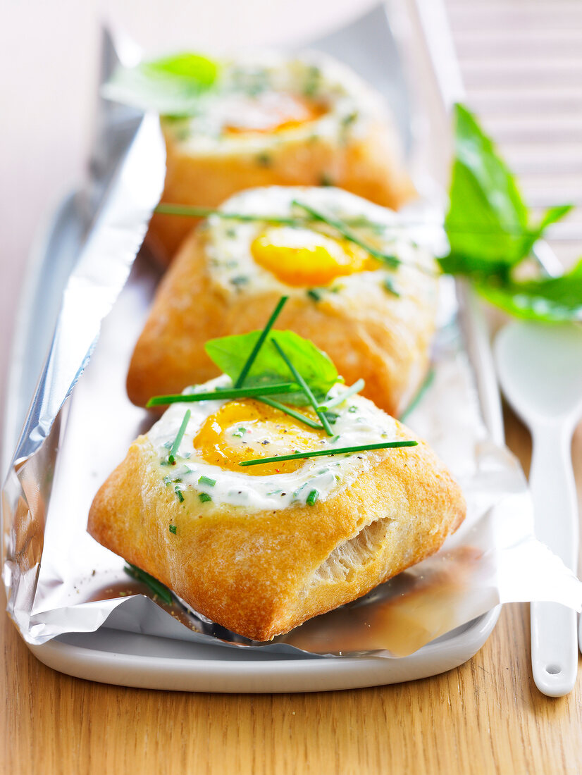 Coodled eggs cooked in individual small breads