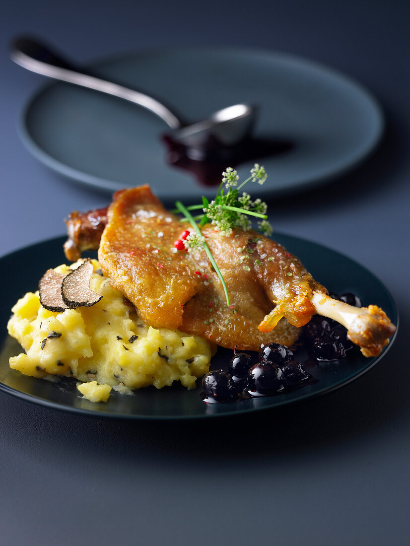 Duck leg confit with bilberries, mashed potatoes with truffles