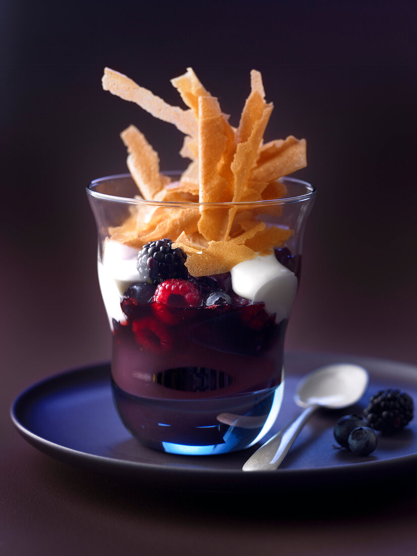Summer fruit in red wine with yoghurt and flaked Gavottes