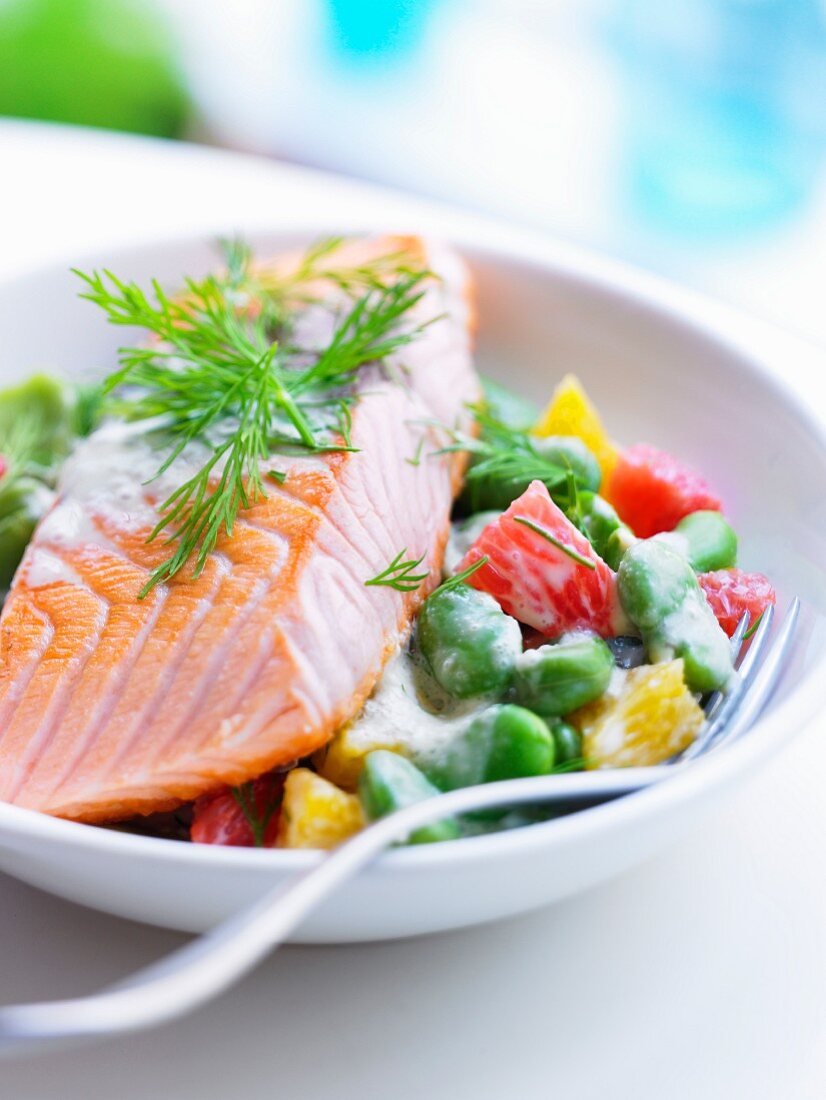 Piece of salmon with broad beans and citrus fruit