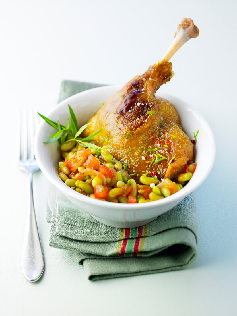 Duck leg with tarragon, flageolet beans cooked with fresh tomatoes