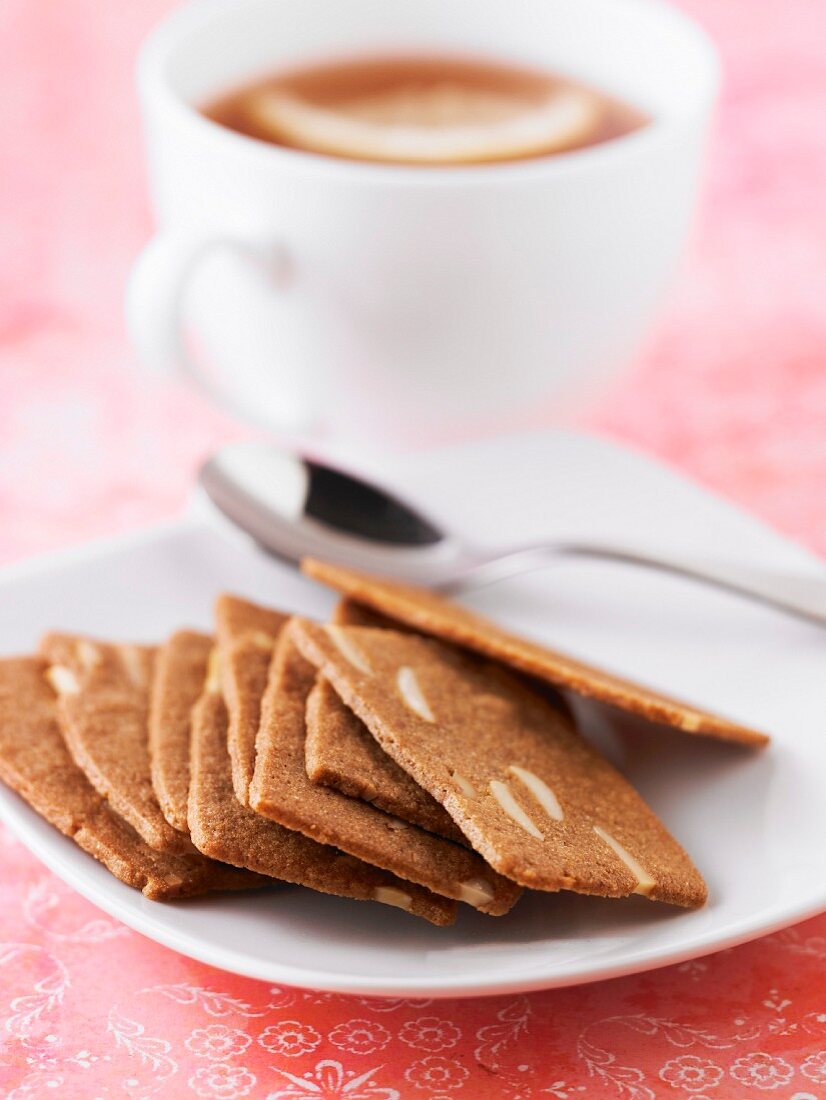 Cinnamon and thinly sliced almond cookies, a cup of coffee