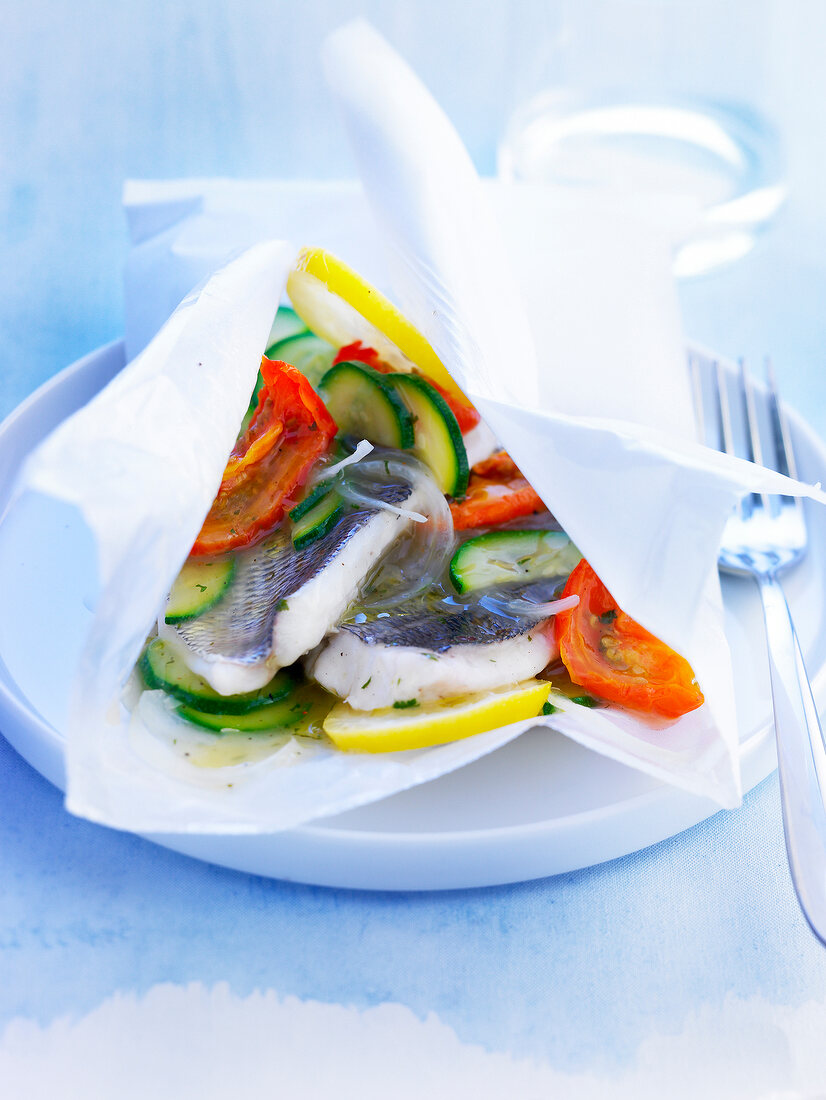 Sea bass and vegetables cooked in wax paper