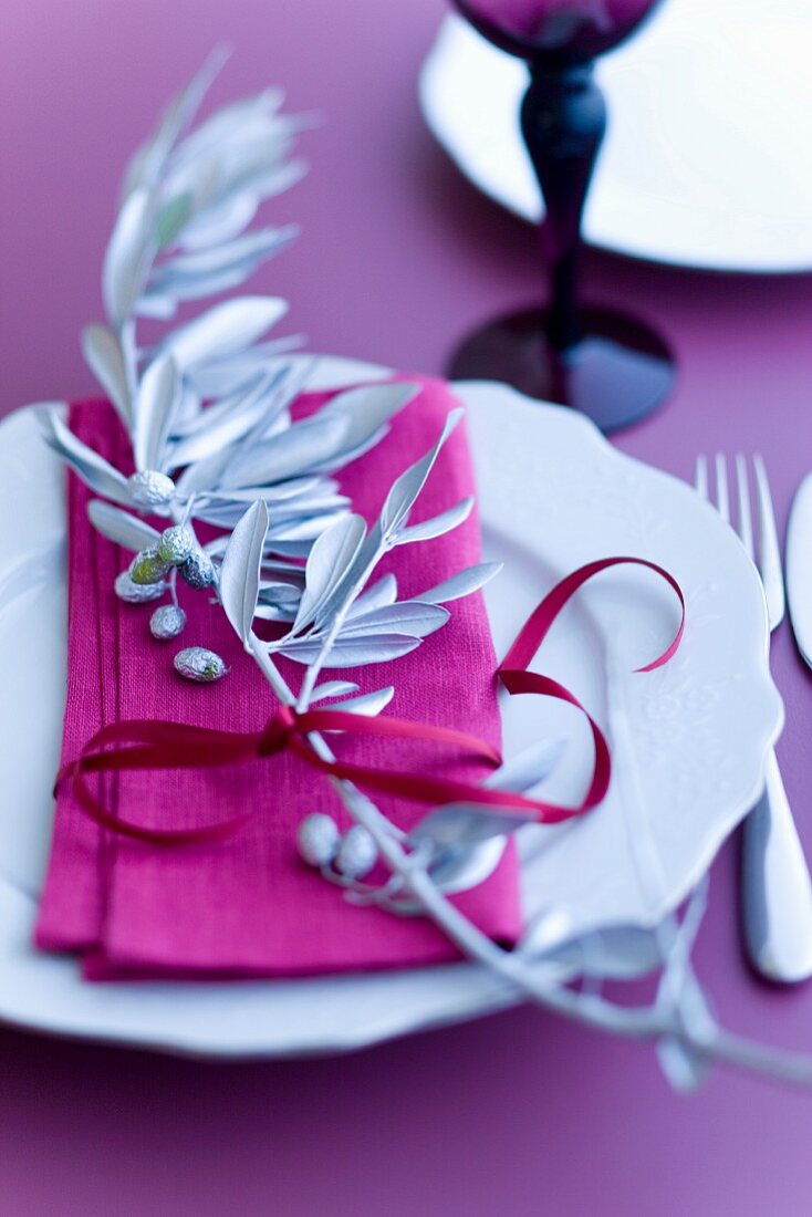 Table decoration with a silver olive branch