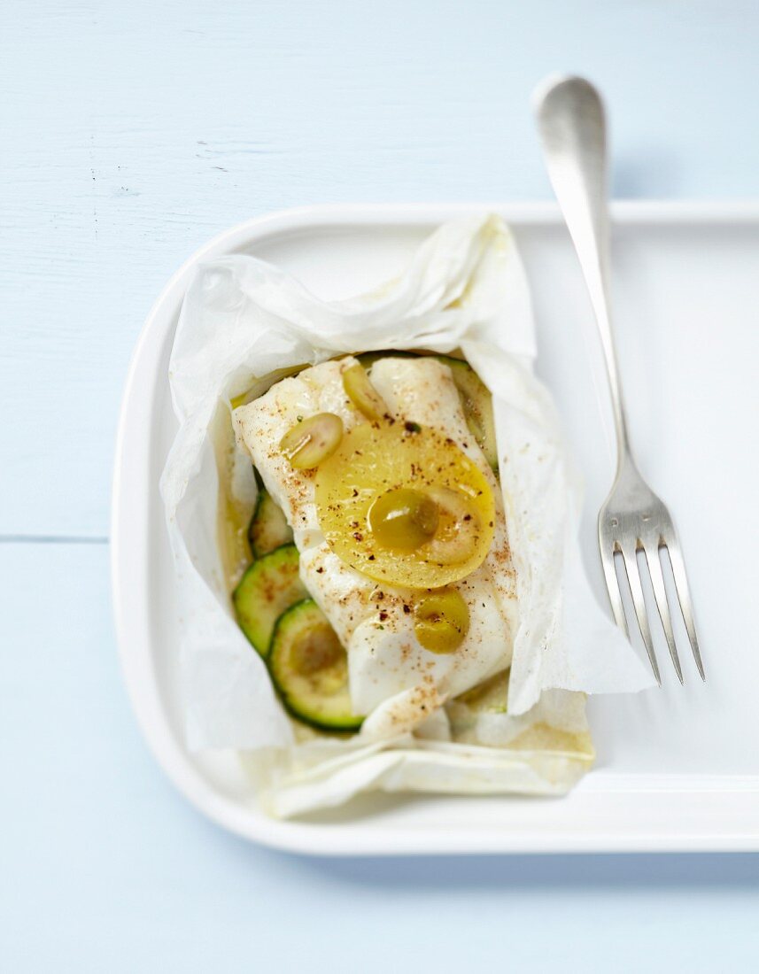Cod with citrus confit and green olives cooked in wax paper