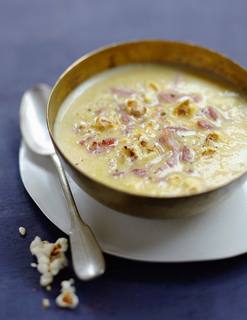 Sweetcorn soup with diced bacon and popcorn