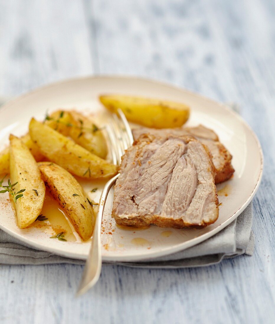 Roast pork marinated in spices,fried potatoes with thyme