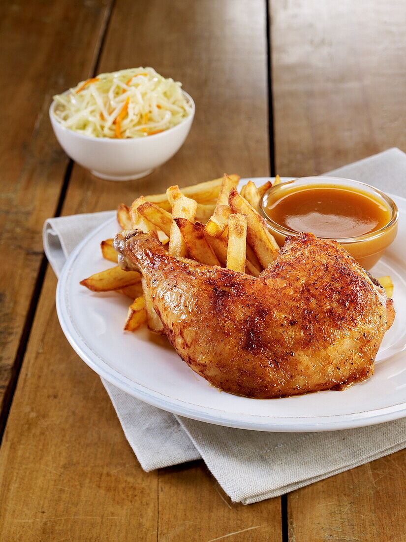 Spicy chicken leg with honey sauce and homemade french fries