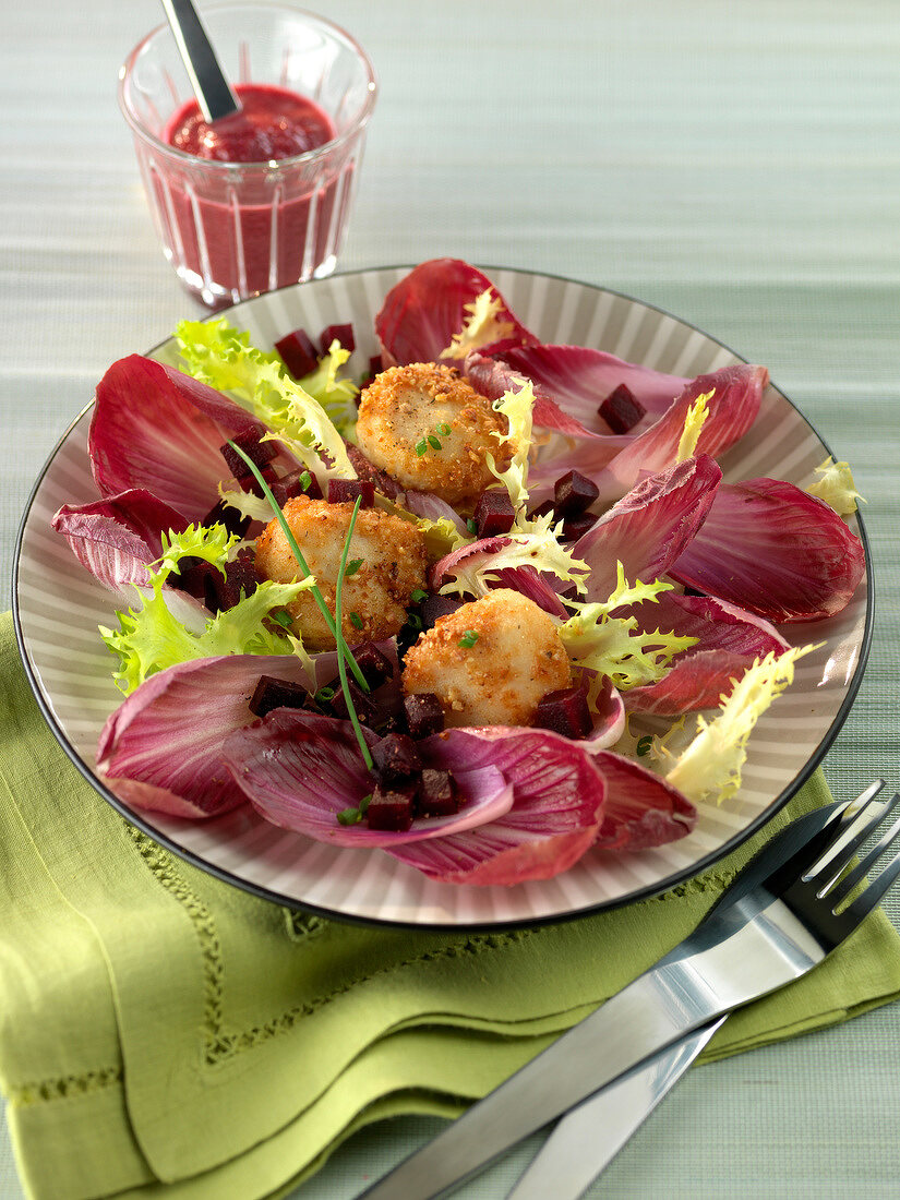 Deep-fried breaded cheese bites with red chicory