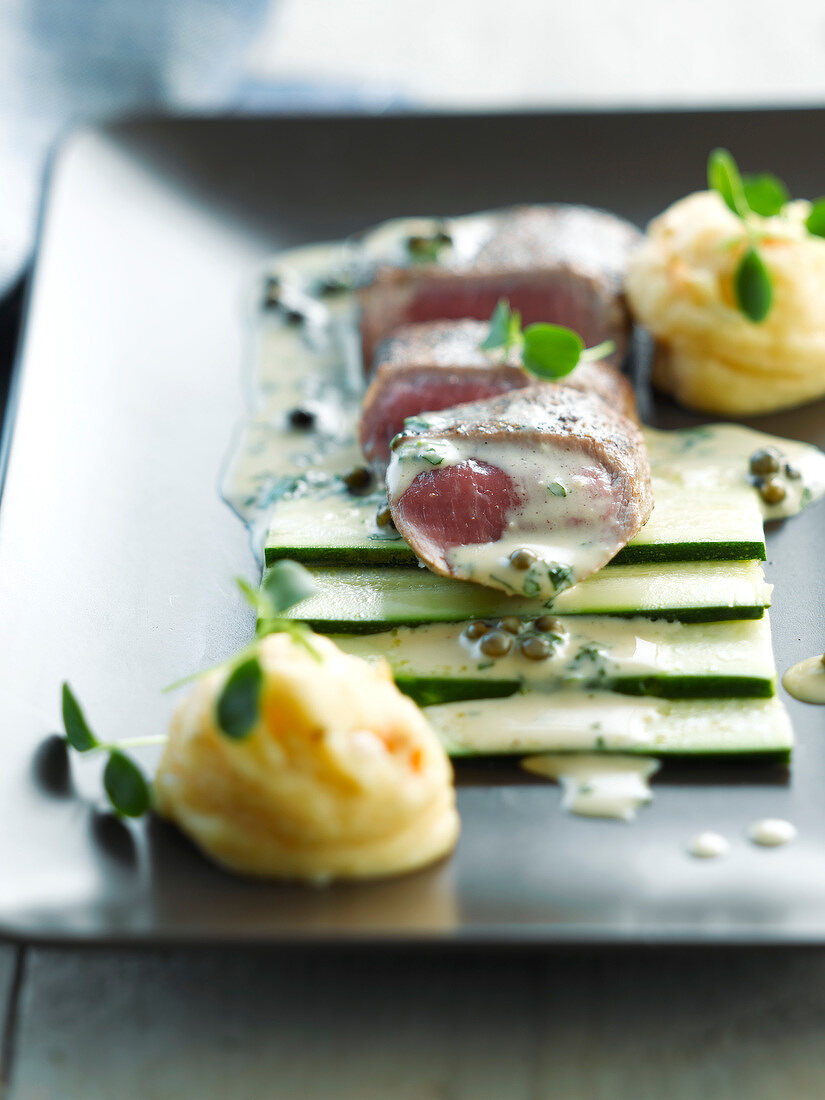 Lamb fillet with raw zucchinis and mashed potatoes with sesame seeds