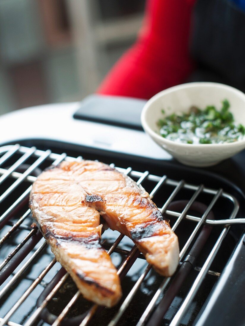 Cooking a salmon steak on an electric barbecue