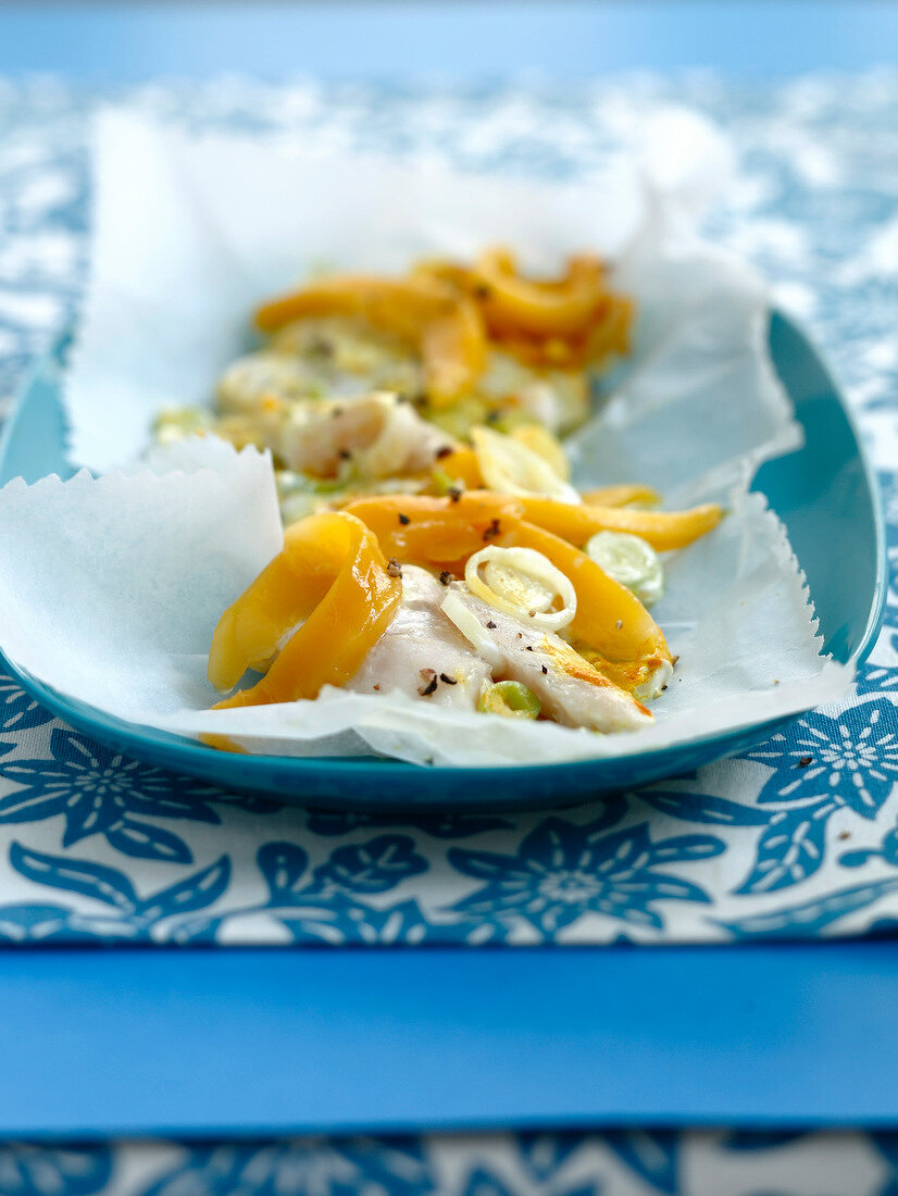 Whiting with mango and sesame seeds steamed in wax paper