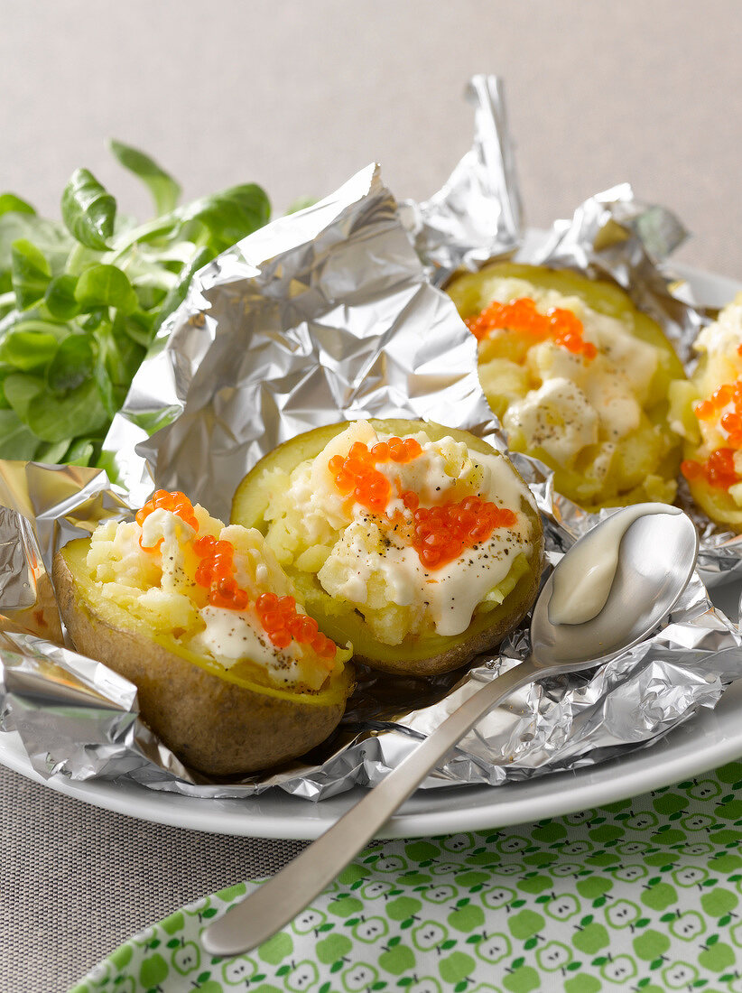 Baked potatoes with cream and salmon roe