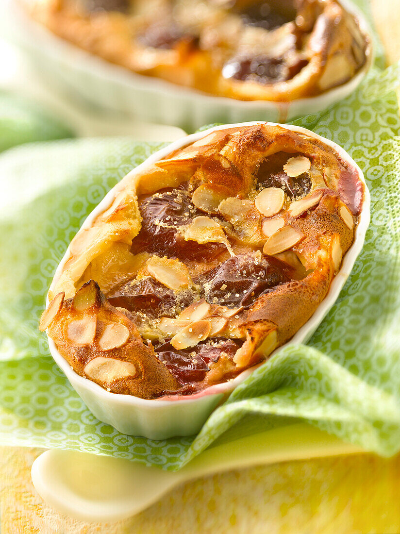 Plum and thinly sliced almond batter pudding