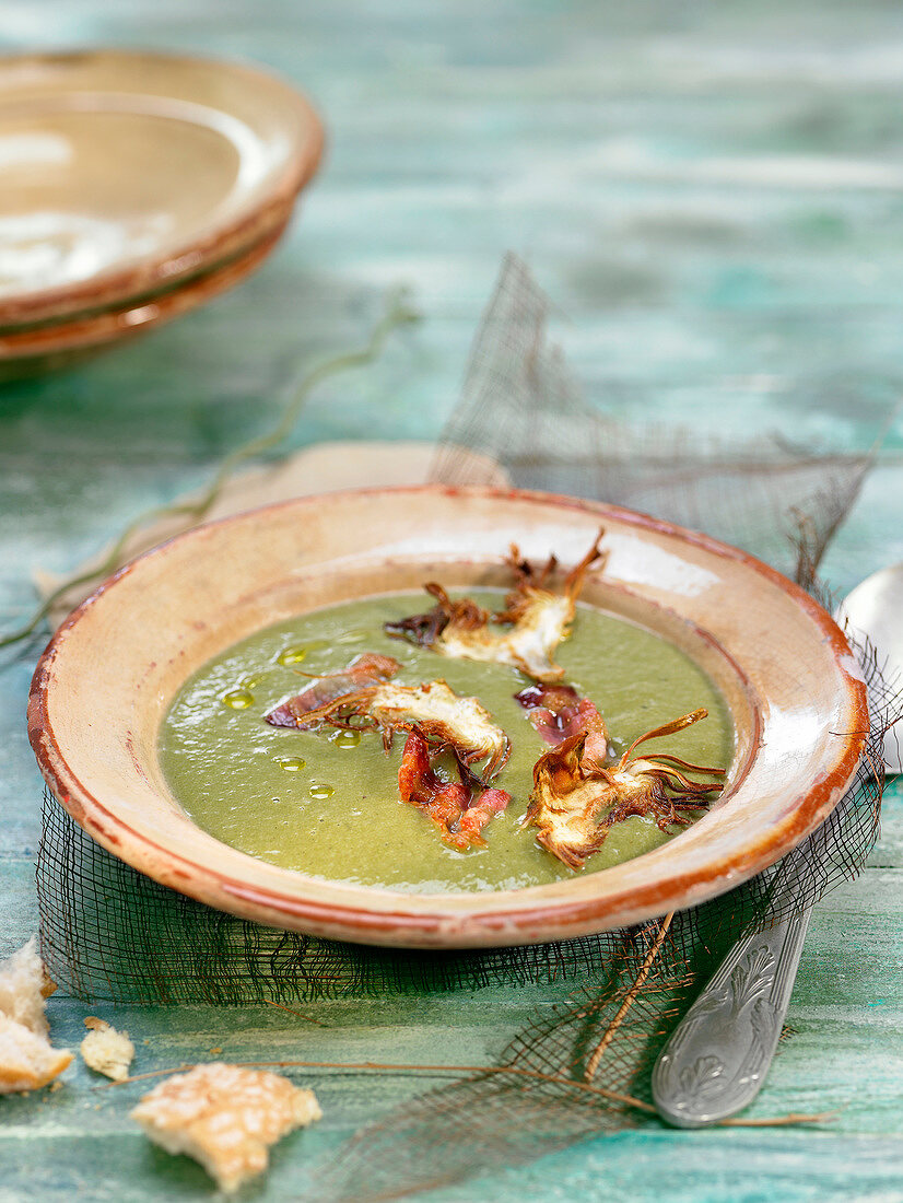 Cream of artichoke soup with diced bacon and cheese