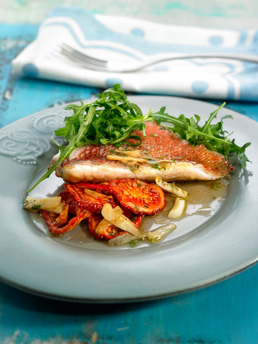 Pink sea bream with confit tomatoes and garlic