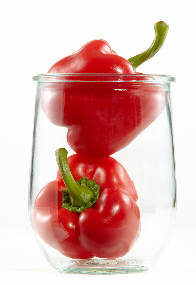 Two red peppers in a jar
