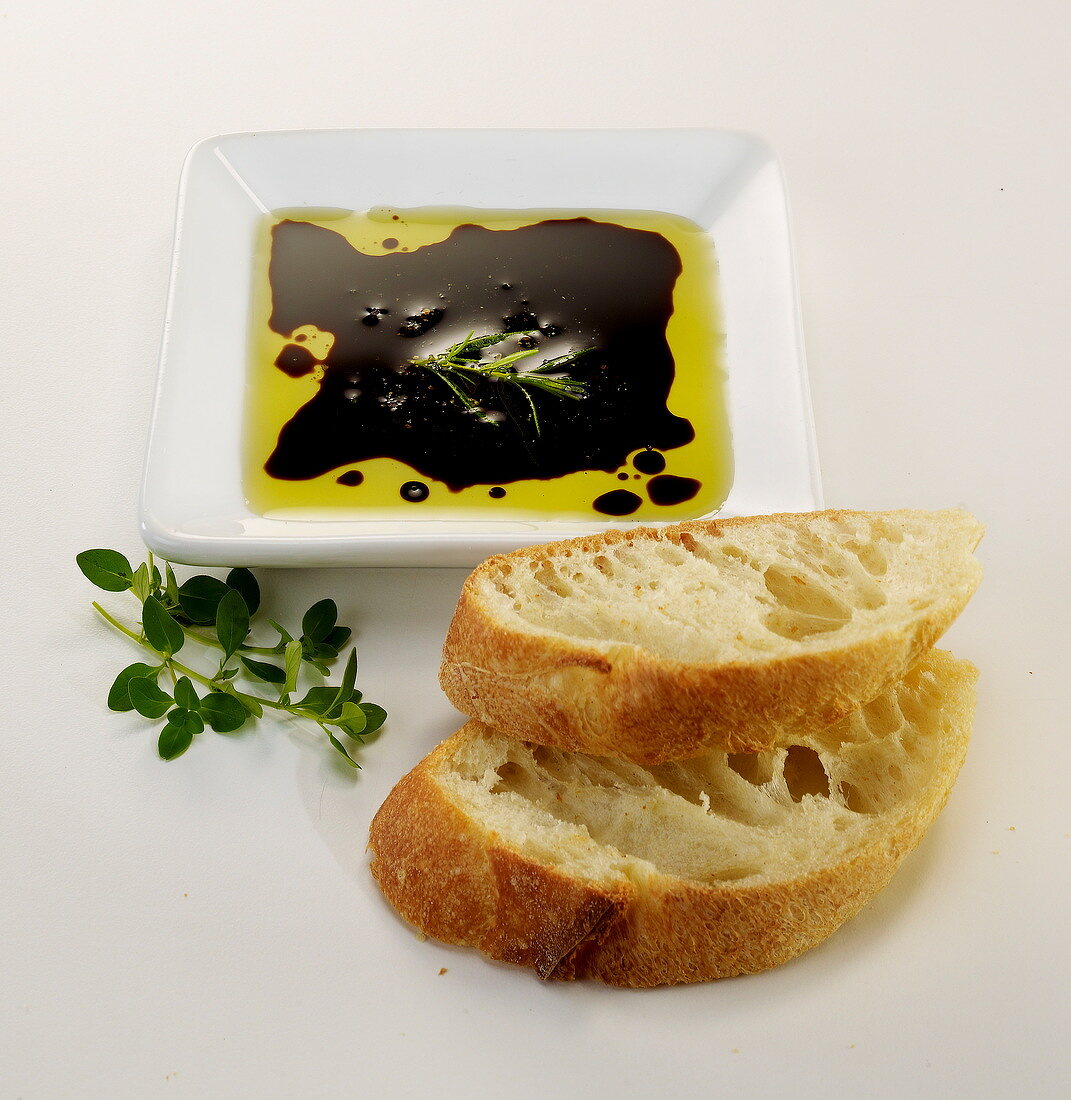 Sliced bread with a small dish of oil and vinaigar