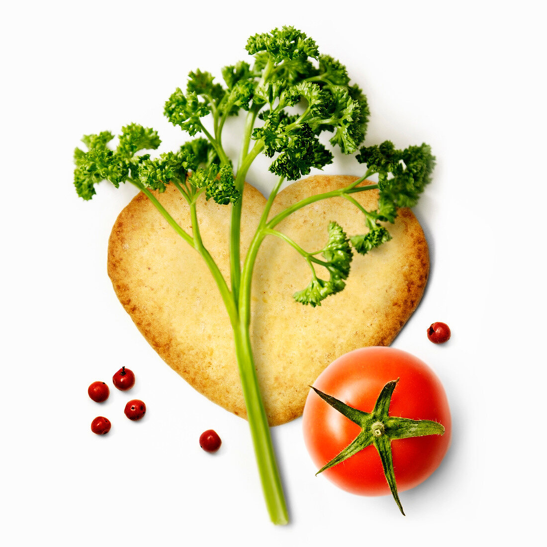 Heart-shaped biscuit with parsley,tomato and pepper