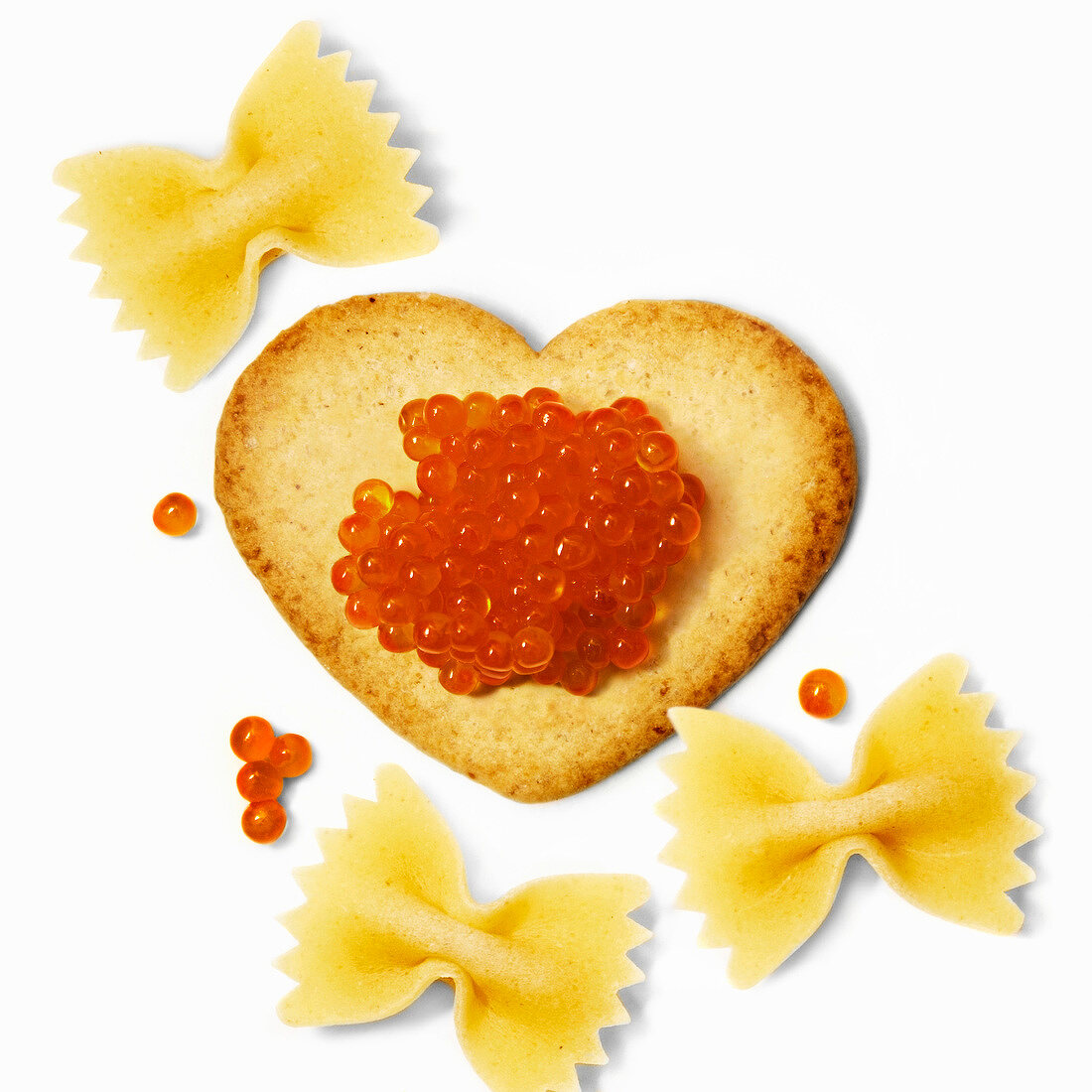 Heart-shaped biscuit with fish roe and farfalle