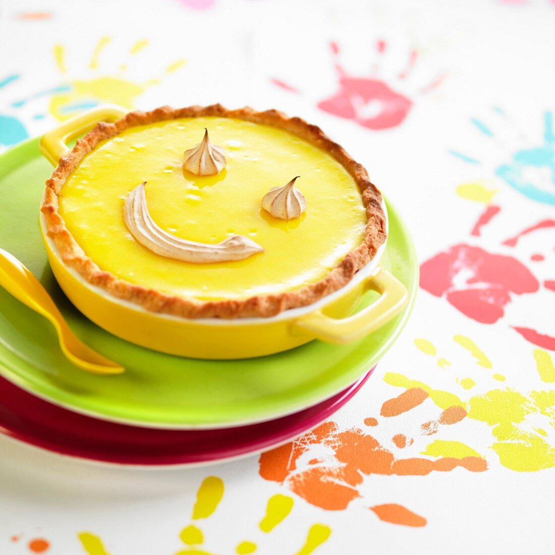 Lemon curd pie decorated with meringue smile