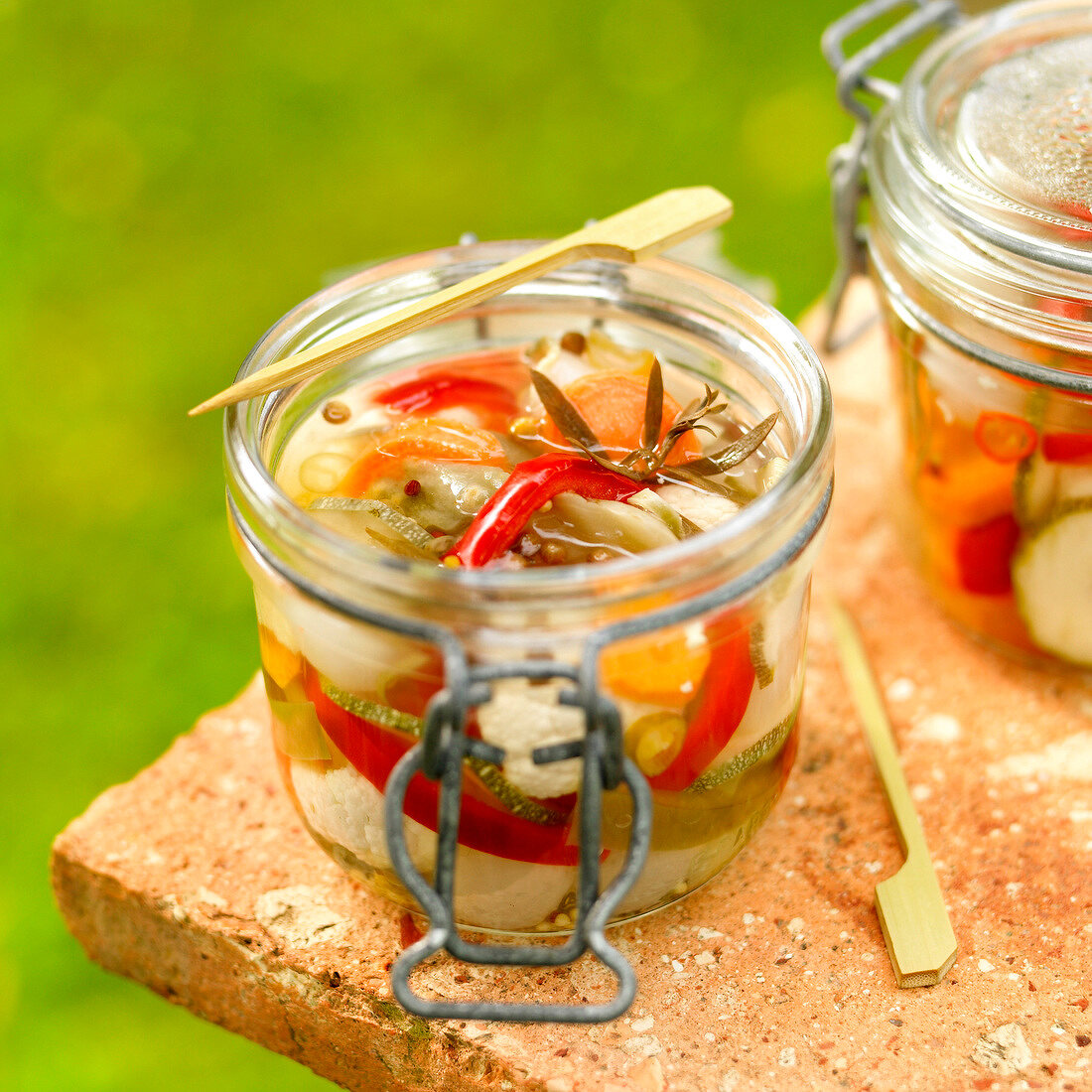 Jar of pickled vegetables with herbs