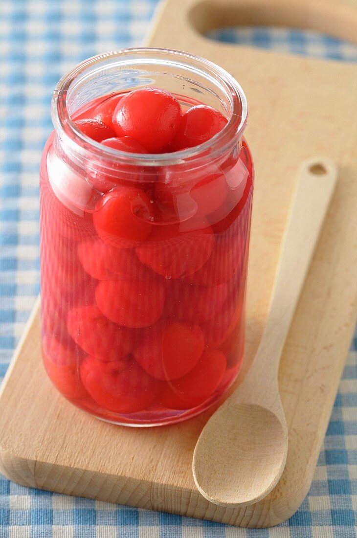 Jar of stewed cherries in syrup