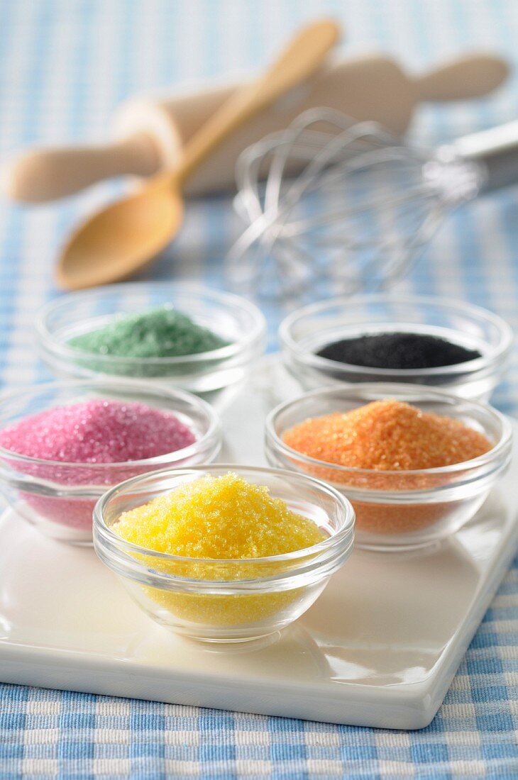 Bowls of different colored sugars