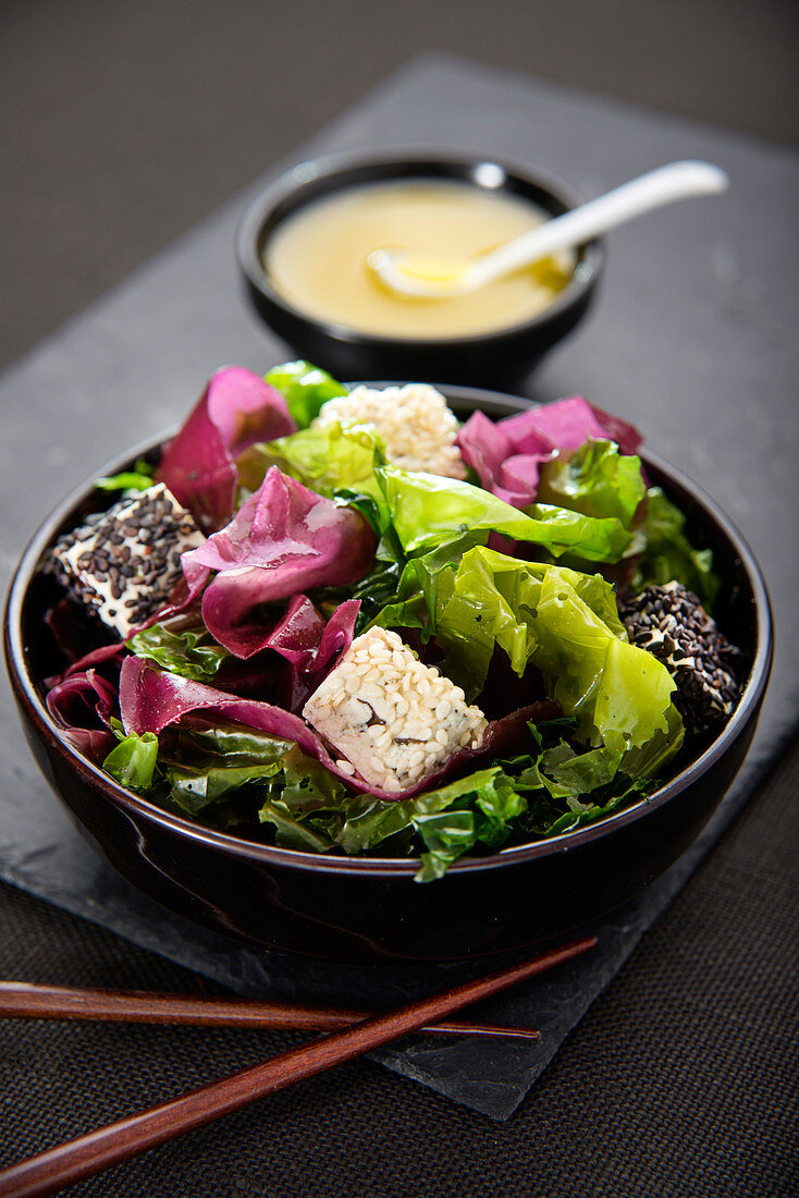 Two seaweed salad with diced tofu and two types of sesame