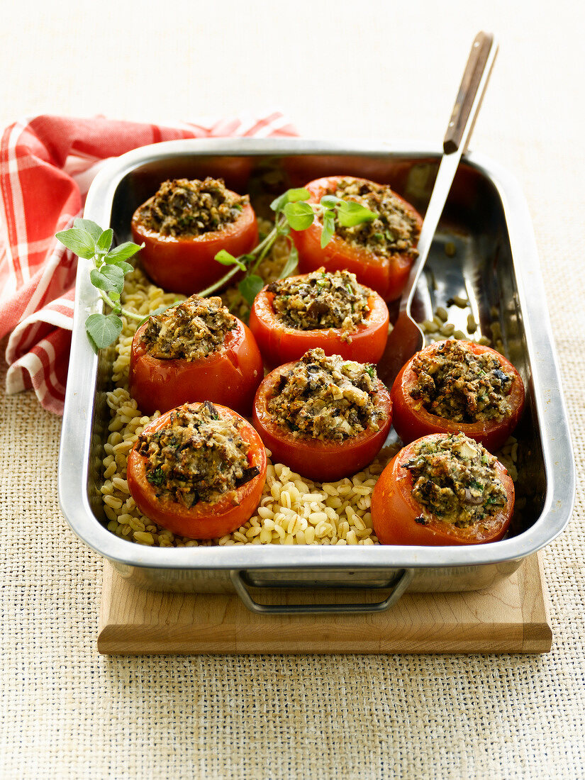 Baked tomatoes stuffed with plain wheat and mushrooms