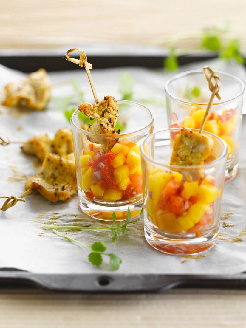 Marinated chicken mini brochettes, diced mangoes and tomatoes