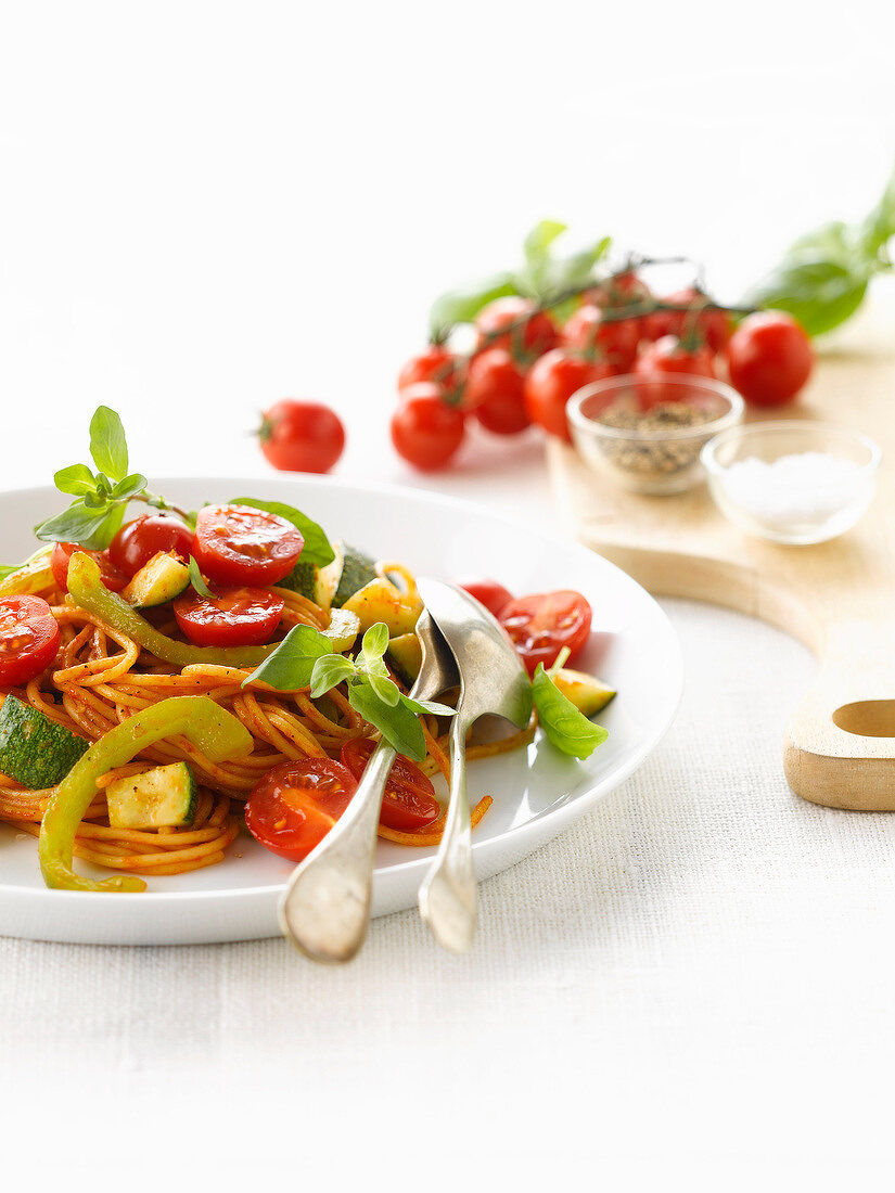 Vegetarian spaghettis with cherry tomatoes,peppers and zucchinis