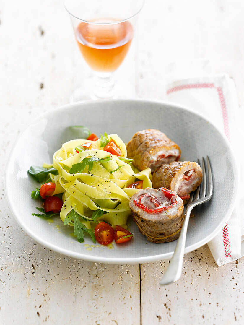 Veal and cheese Saltimbocca ,tagliatelles with cherry tomatoes and rocket lettuce
